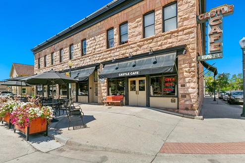 Outdoor seating and entry to iconic and historic Castle Café, Bar and Lounge at 403 Wilcox Street in Castle Rock Colorado