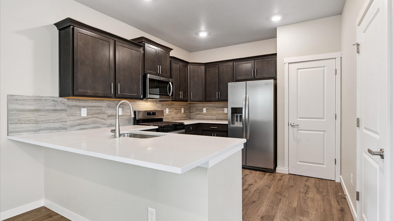 Spacious kitchen island perfect for entertaining in new home in Watkins, Colorado