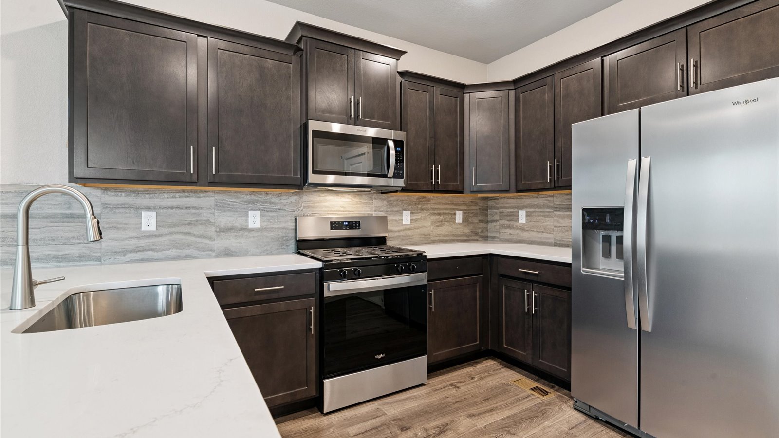 Kitchen with new finished in Sky Ranch community in new Watkins, Colorado home