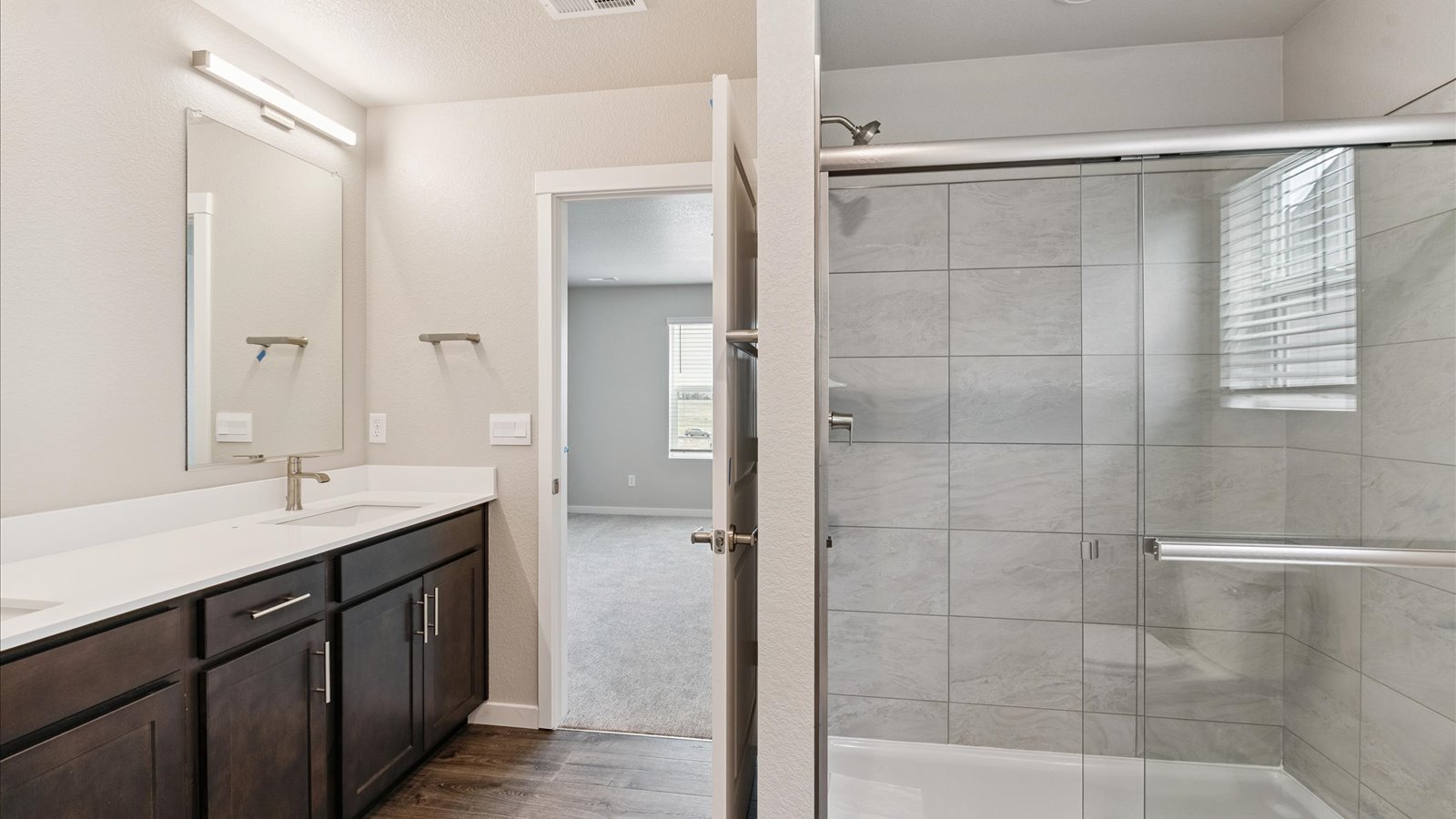 Private attached primary bathroom with ample counter space