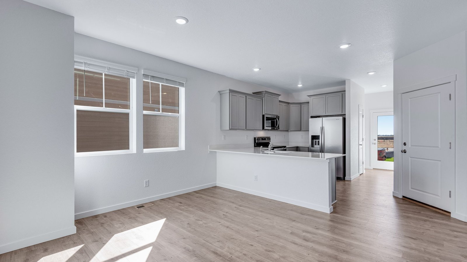 Dining space with large windows in new home at Sky Ranch Community