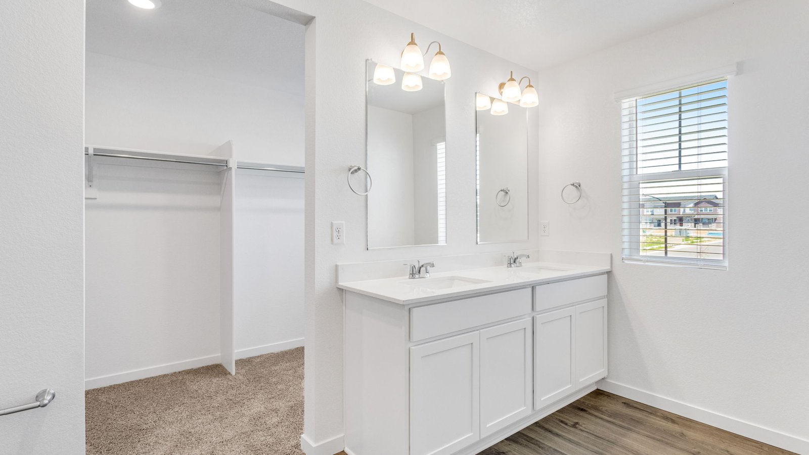Attached private bathroom with dual vanity sinks in new home in Watkins Colorado