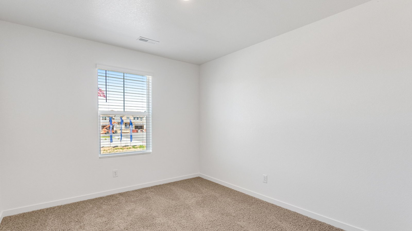 Secondary bedroom with large window in new home in Watkins Colorado