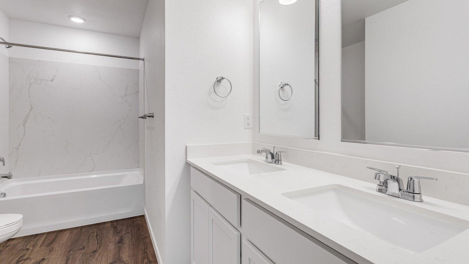 Secondary bathroom with dual vanity sinks in new home in Watkins Colorado