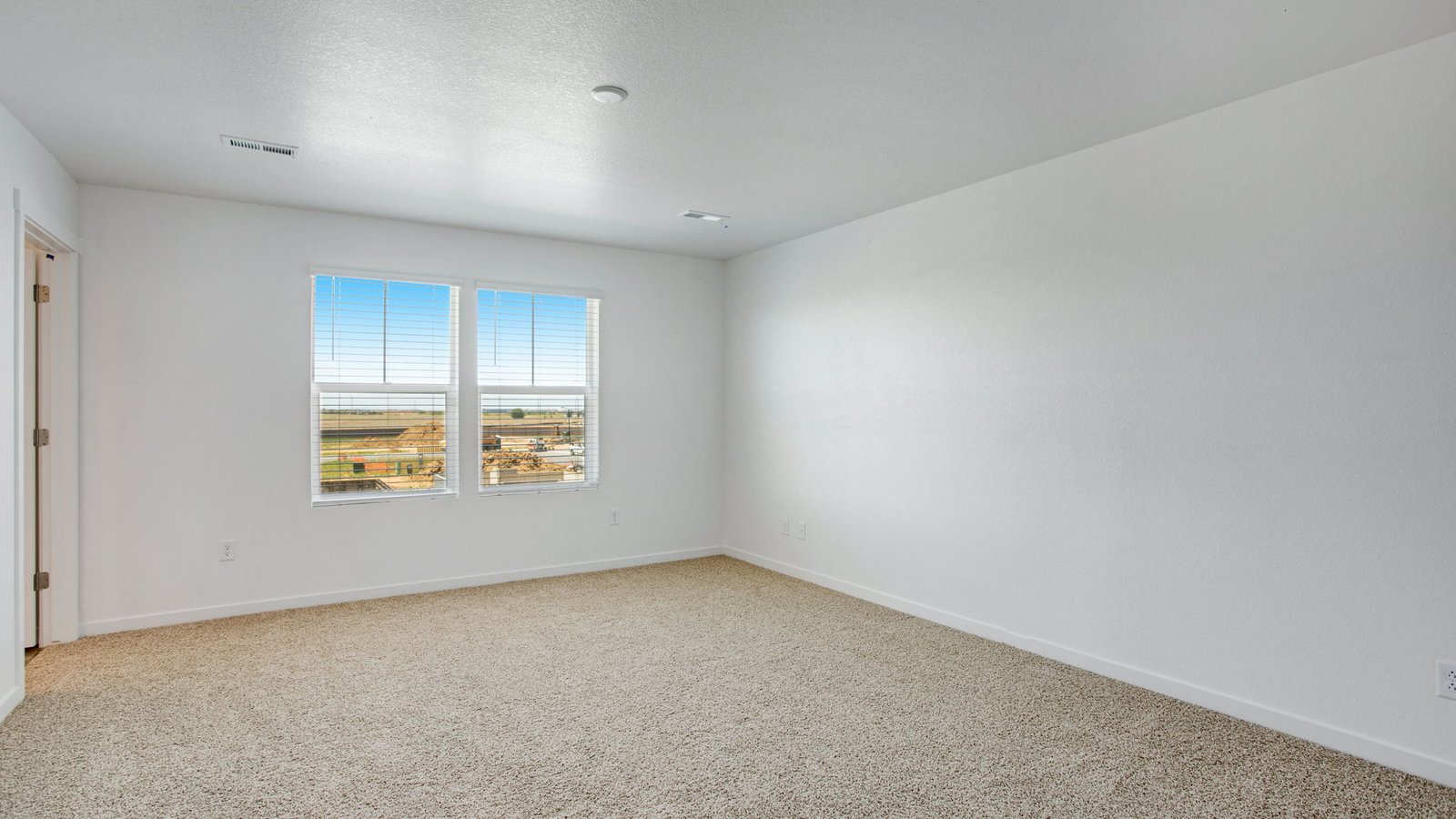 Spacious primary bedroom in new home in Watkins Colorado