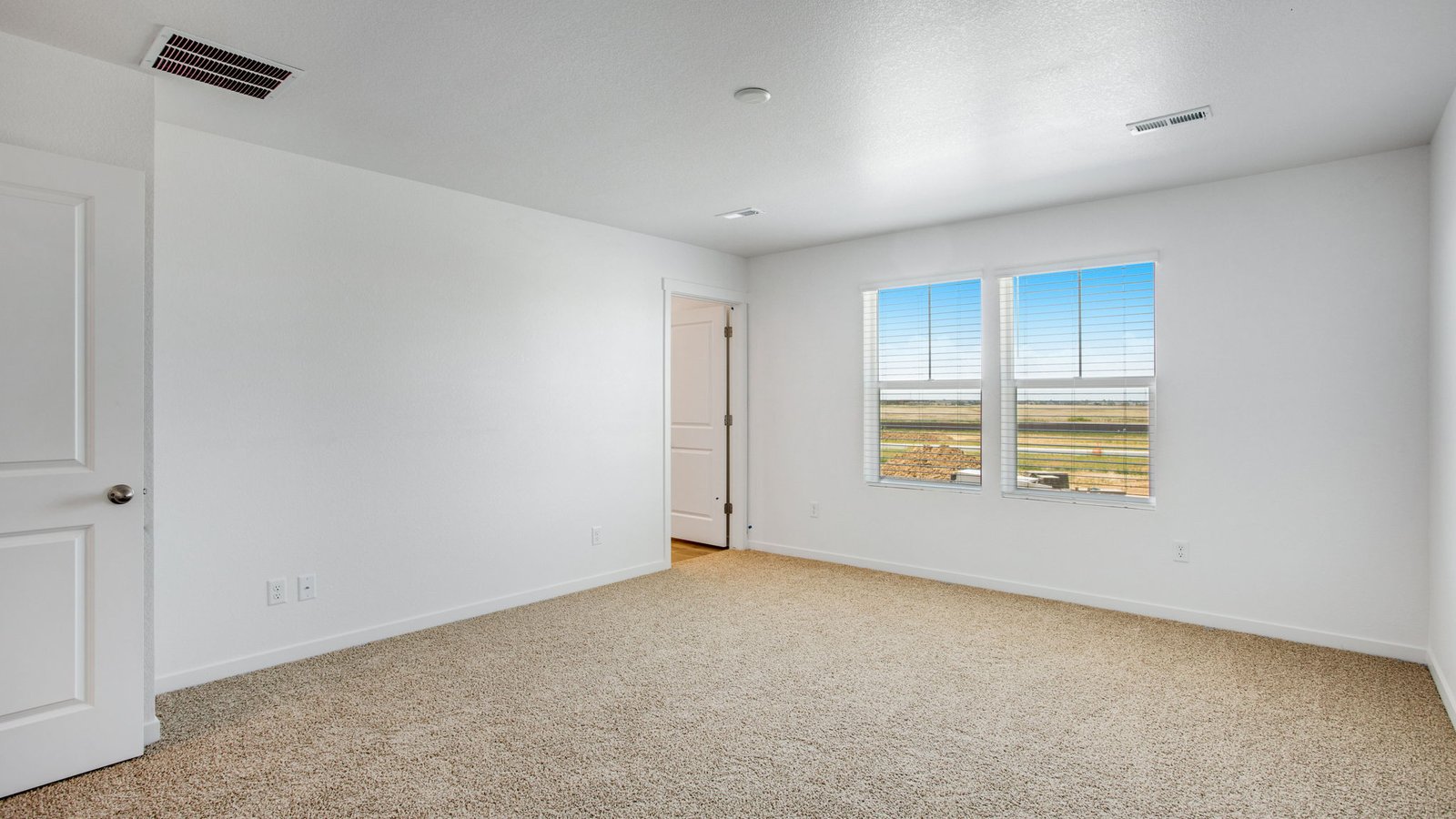 Spacious primary bedroom in new home in Watkins Colorado
