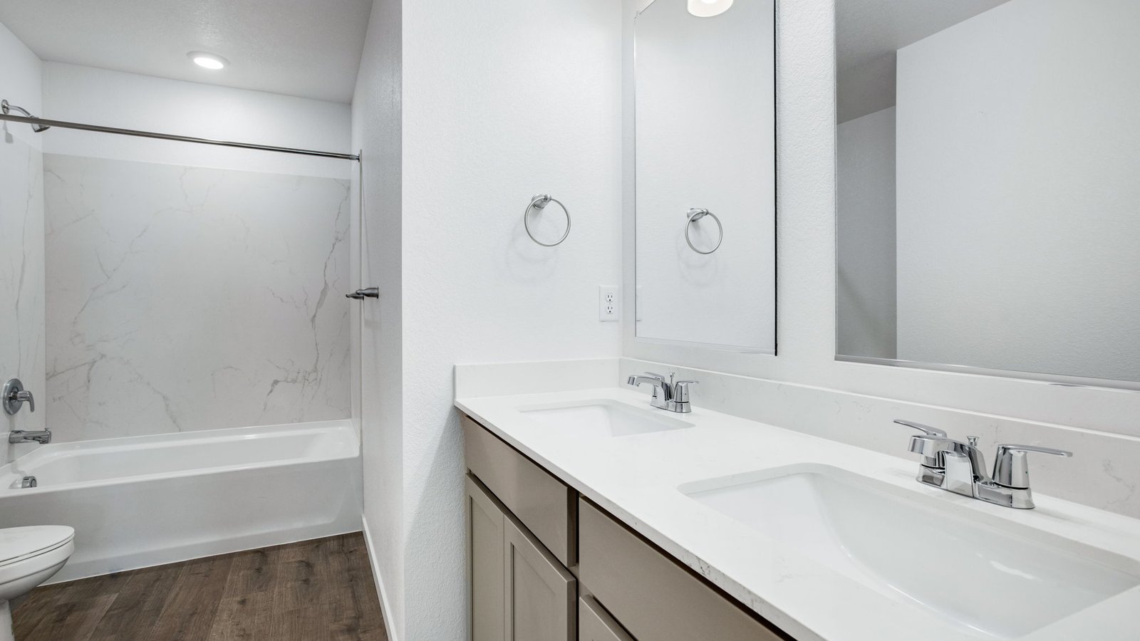 Secondary bathroom with dual vanity sinks in new home community Sky Ranch