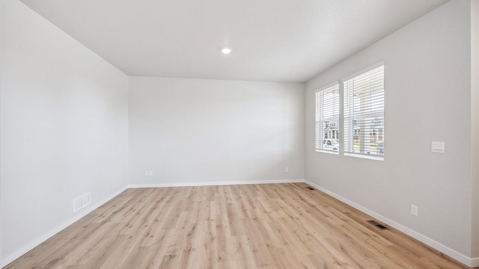 Open-concept great room with natural light and seamless connection to kitchen and dining area.