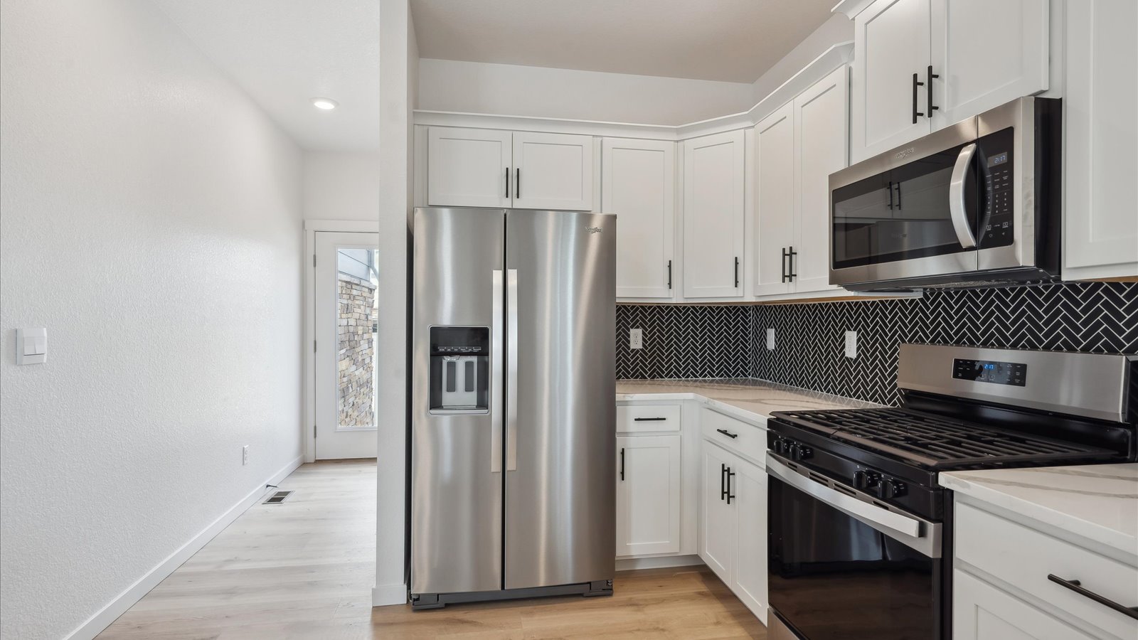 stainless steel appliances in kitchen of new construction home by D.R. Horton Aurora, CO