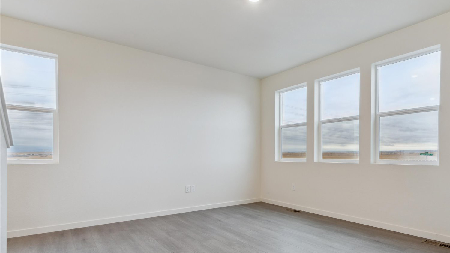Living room of open concept Edmon layout in new home at Watkins Colorado