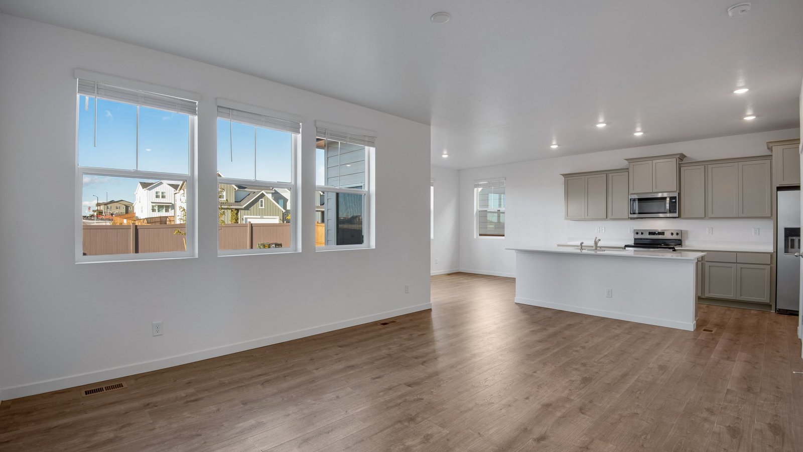 Open concept living with natural light in new home in Watkins Colorado