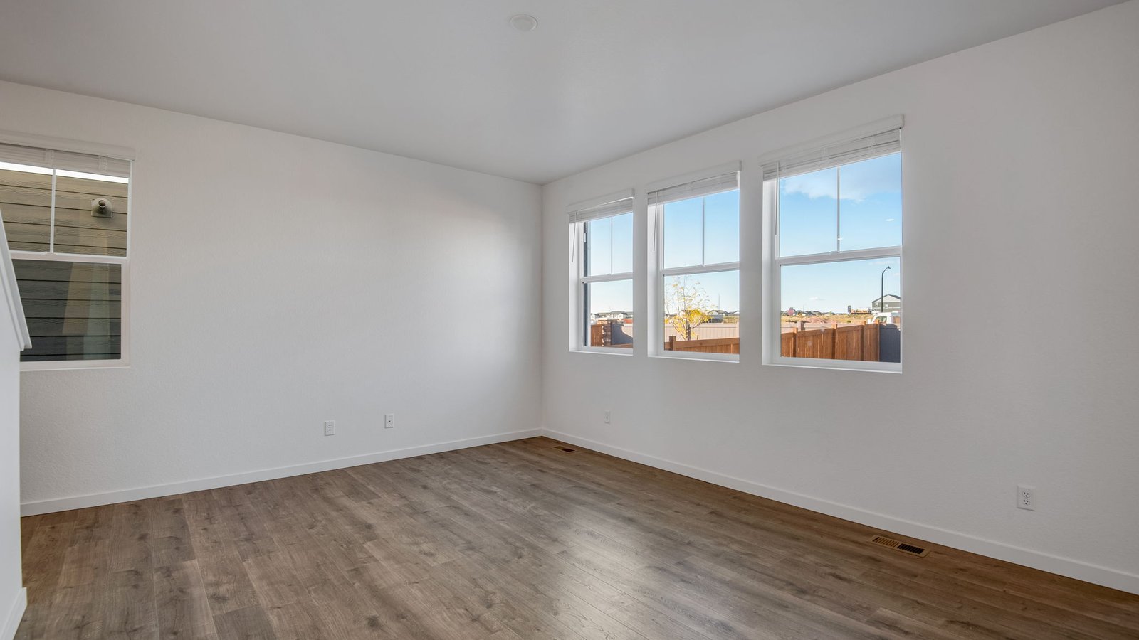 Living area with large windows in new home in Sky Ranch Community
