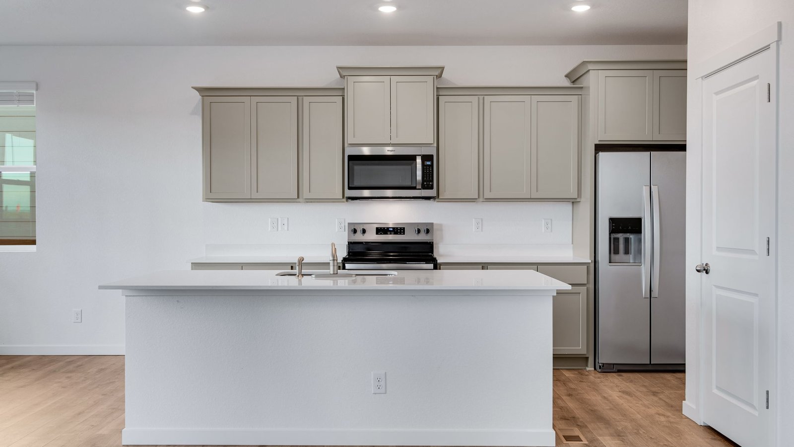 Kitchen with new finishes at new home community Sky Ranch