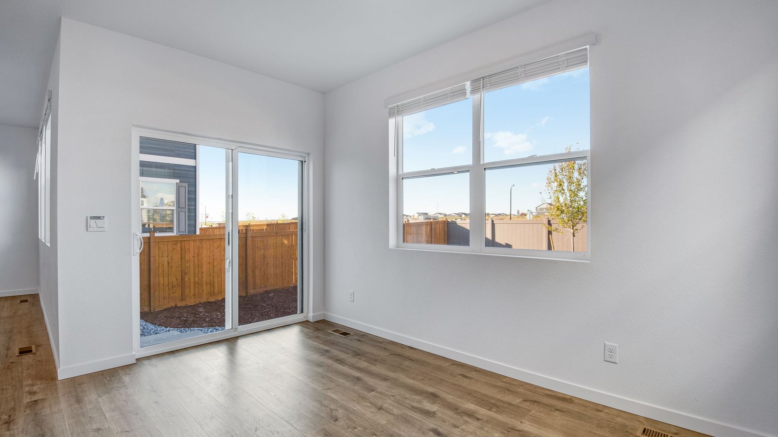 Dining room with large windows in new home in Watkins Colorado