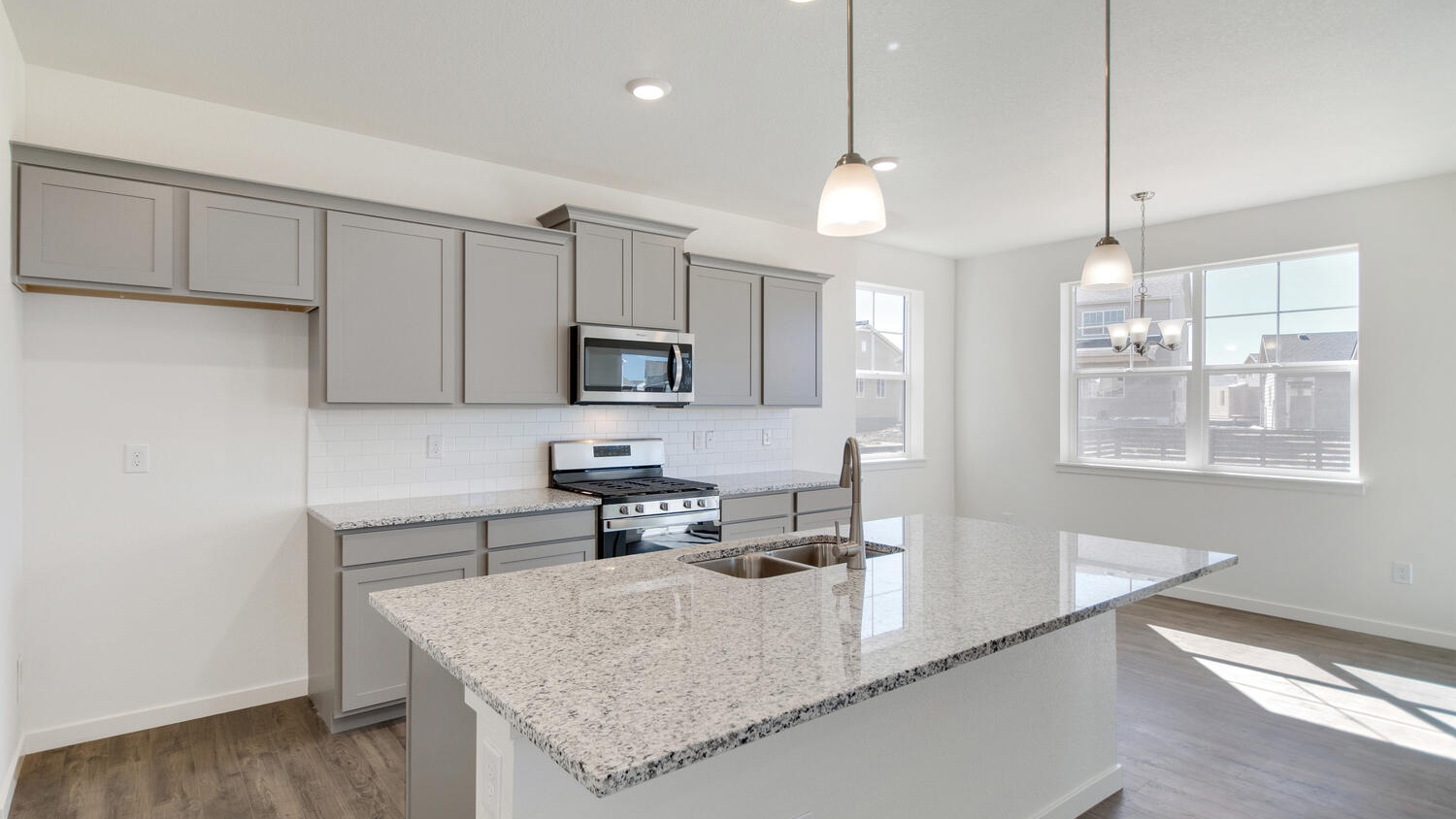 Spacious kitchen in pine floor plan featuring gray cabinetry