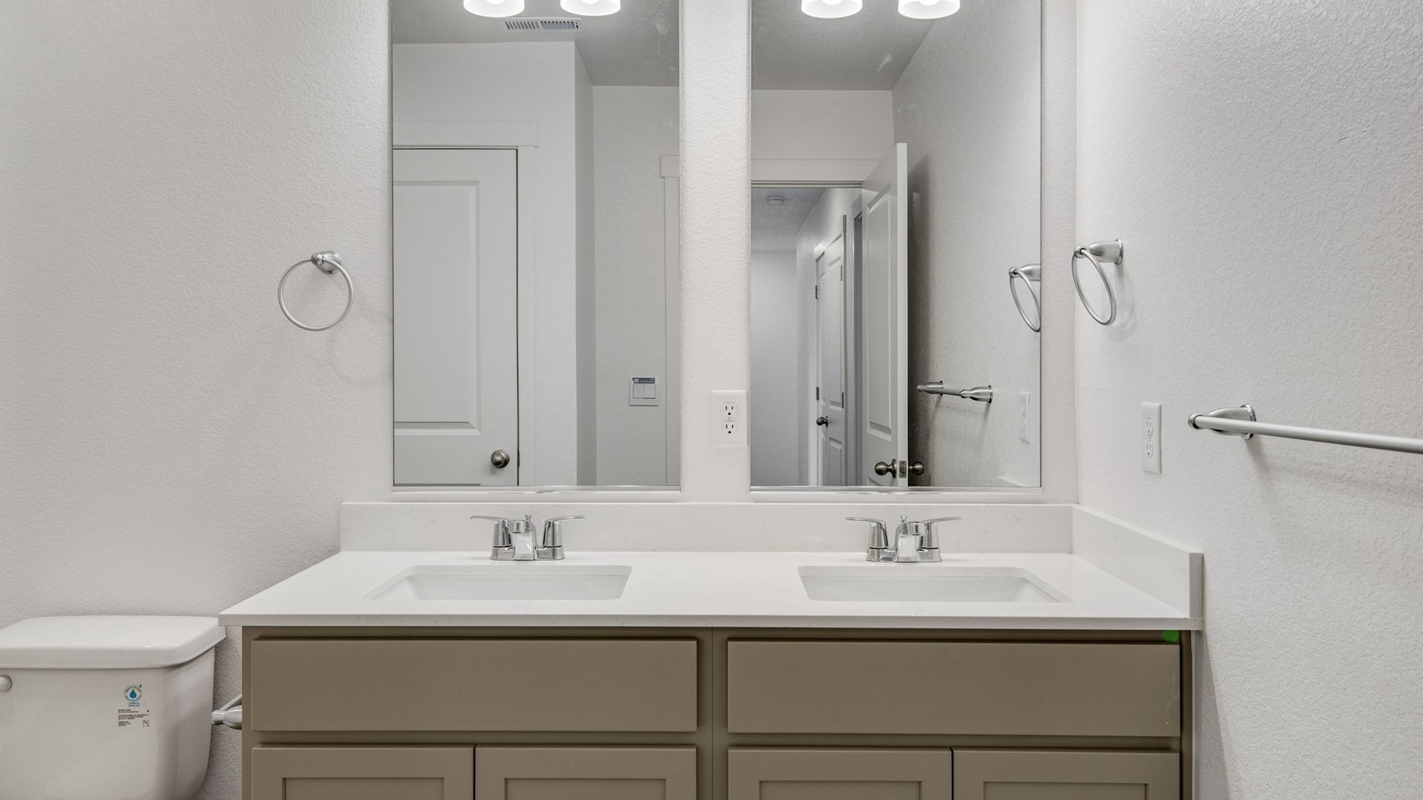 Secondary bedroom with dual vanity sinks in new home at Arcadia community