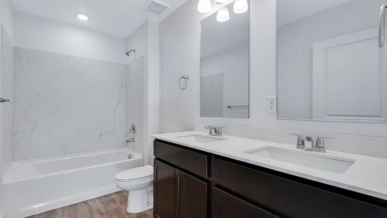 Secondary bathroom in new home in Watkins Colorado with dual vanity sinks
