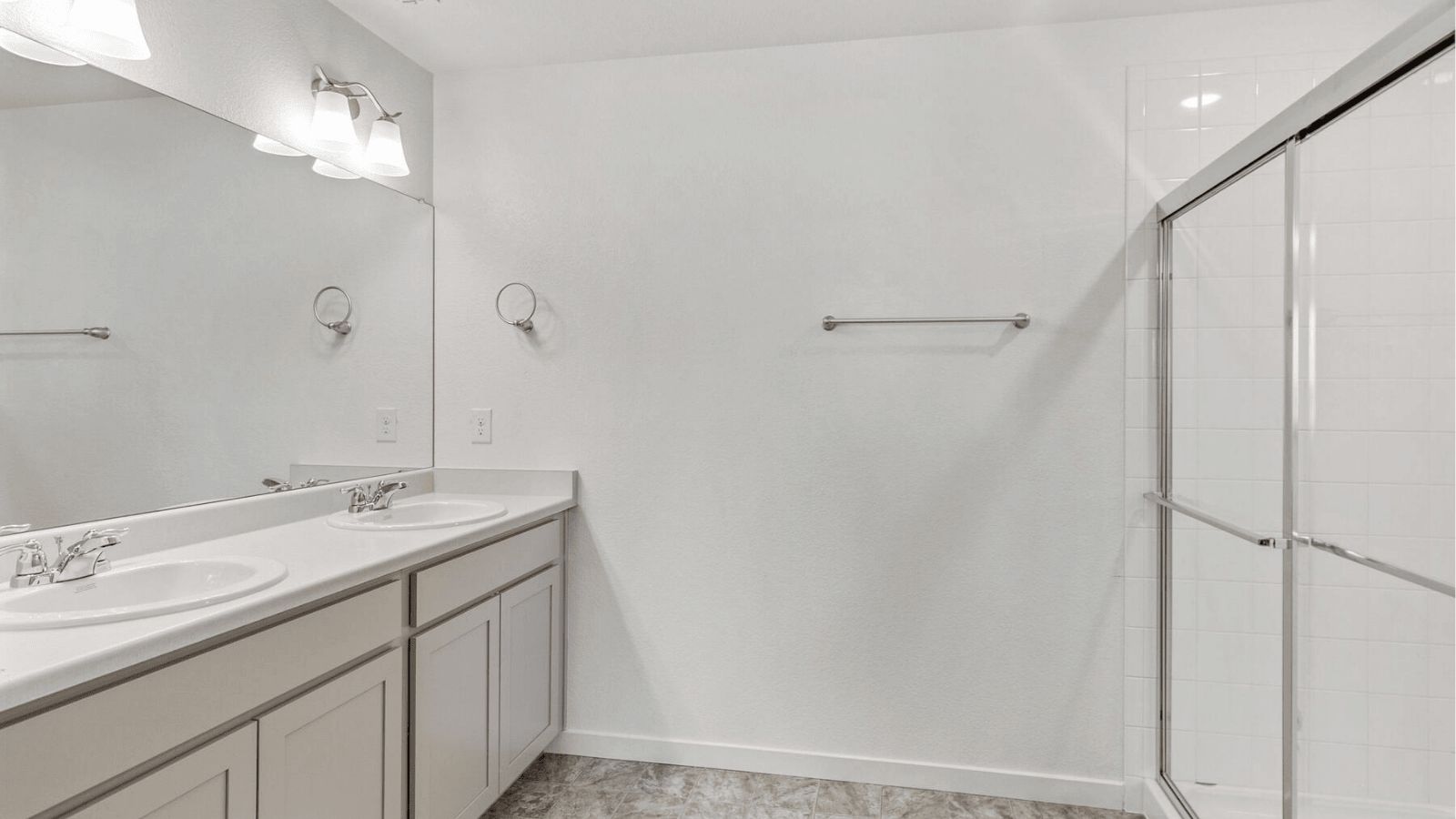 Primary bathroom in the Elm at Sky Ranch with dual sinks and modern finishes.