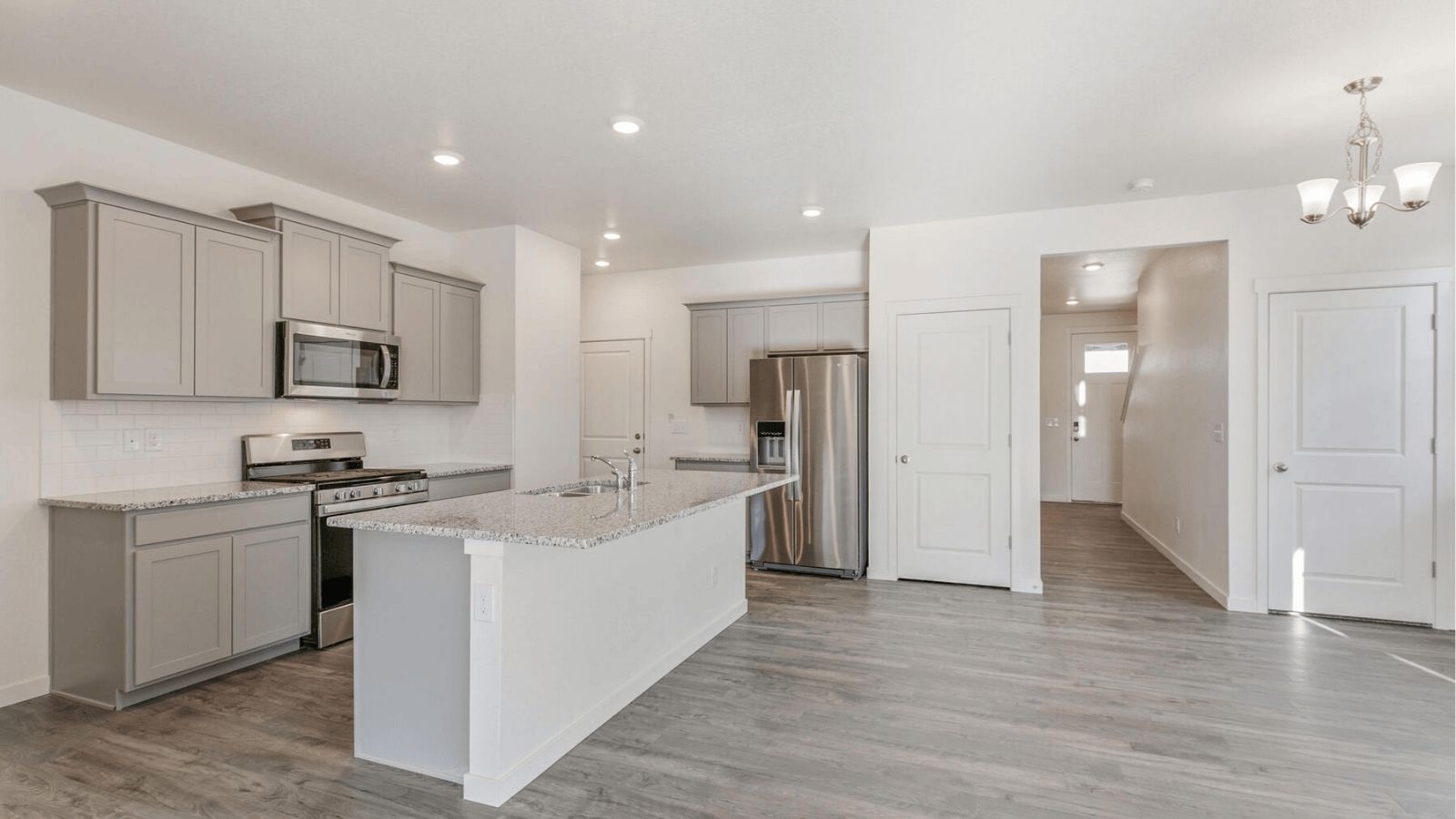Contemporary kitchen in the Elm floor plan at Sky Ranch featuring spacious counters and sleek finishes.