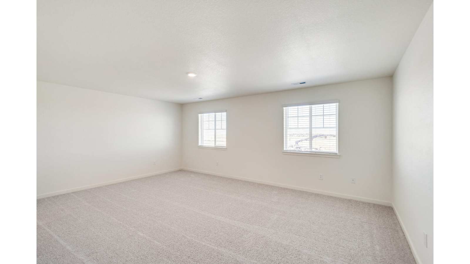 Spacious primary bedroom of new D.R. Horton home in Watkins, Colorado