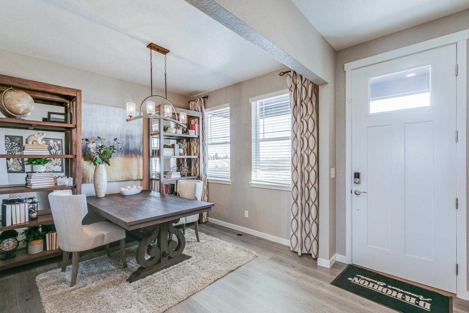 Bridgeport study with two windows staged with table, chairs and bookshelves