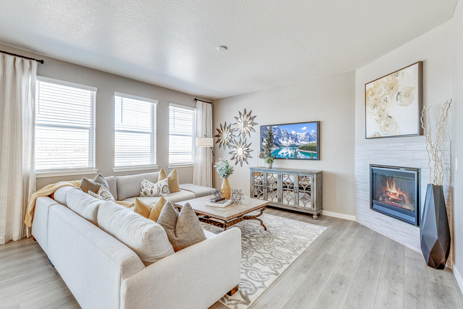 Bridgeport great room with three windows and fireplace with tile backsplash