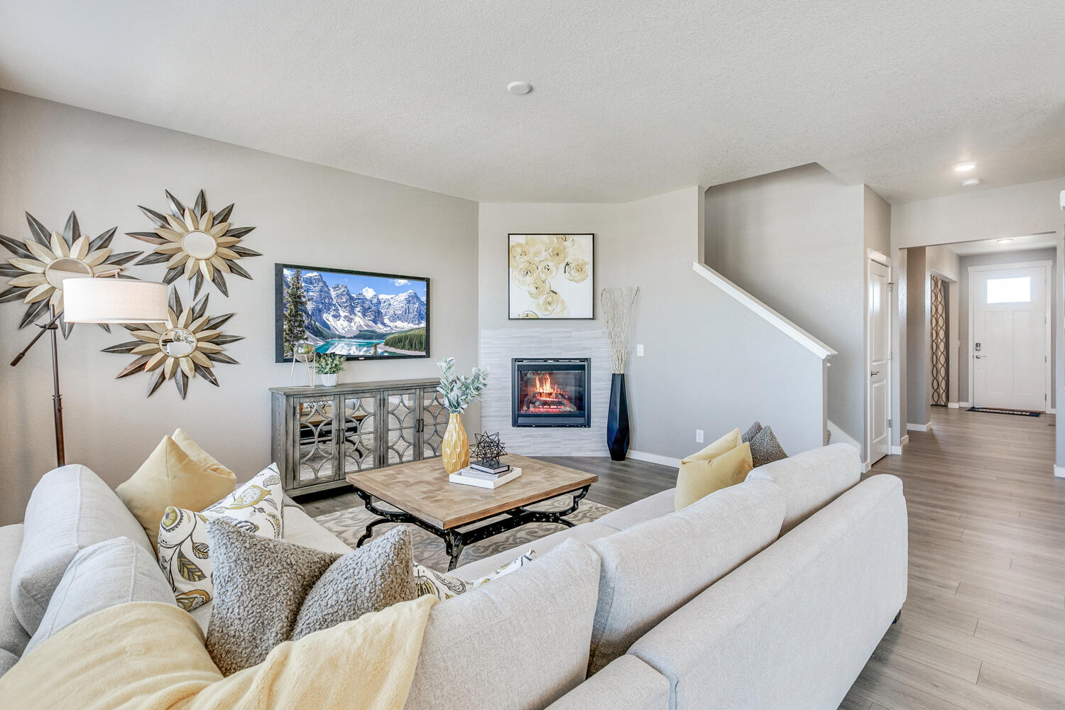Alternate view of great room staged with sectional couch oriented towards fireplace