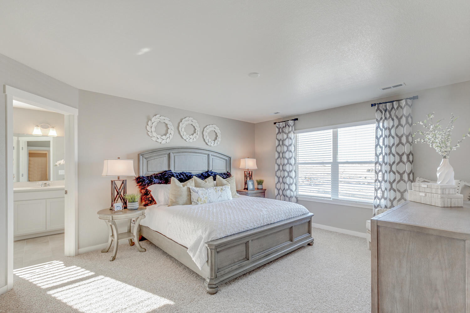 Bridgeport primary bedroom view showing private bath entrance and large window