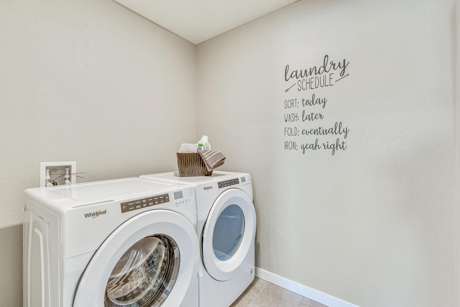 Model home laundry room with washer and dryer
