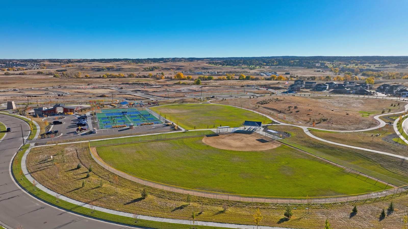 Trails at Crowfoot community  by D.R. Horton fields and sport courts connected by walking paths in Parker, Colorado