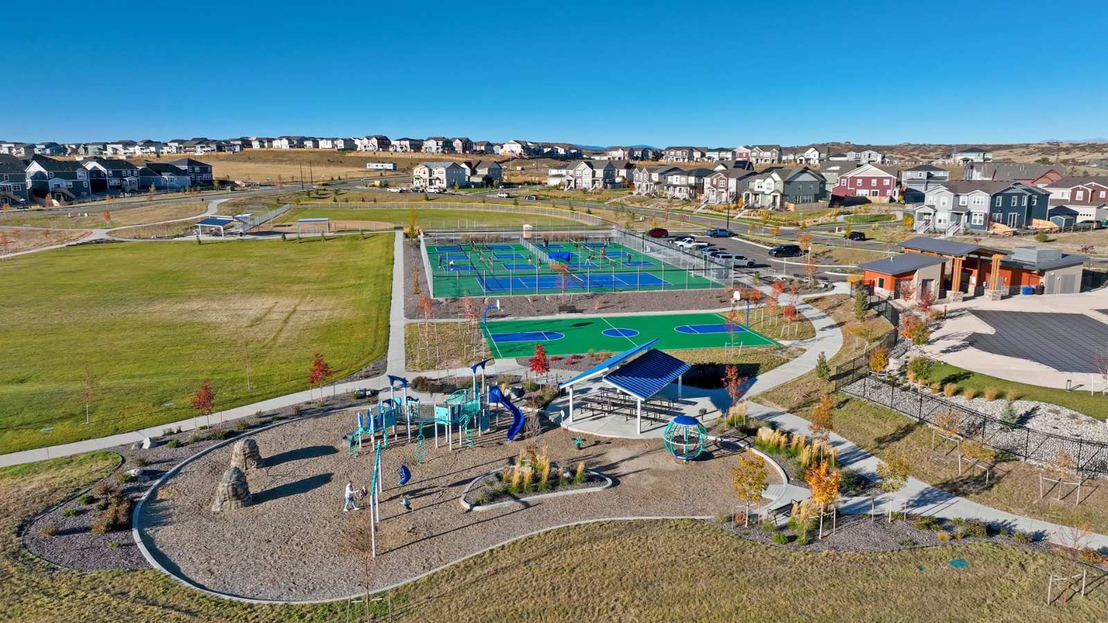 Aerial shot of Trails at Crowfoot amenities including playground, green space, basketball and tennis courts in Parker, CO