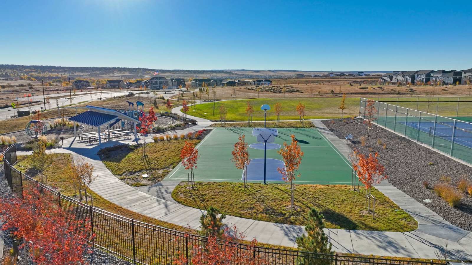 Walking paths connecting covered picnic area, sport courts and green space in D.R. Horton Colorado community in Parker, CO