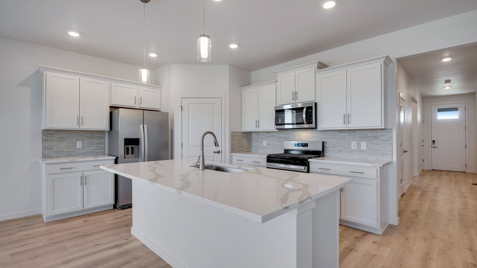 Kitchen with white cabinets in new construction home