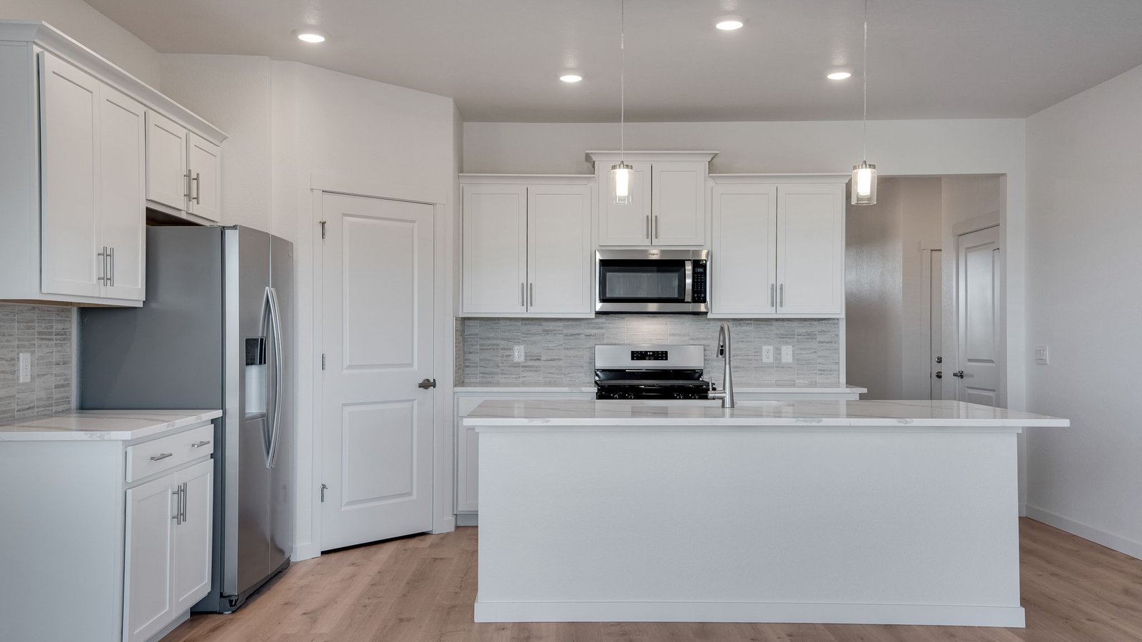 Kitchen with white cabinets in new home