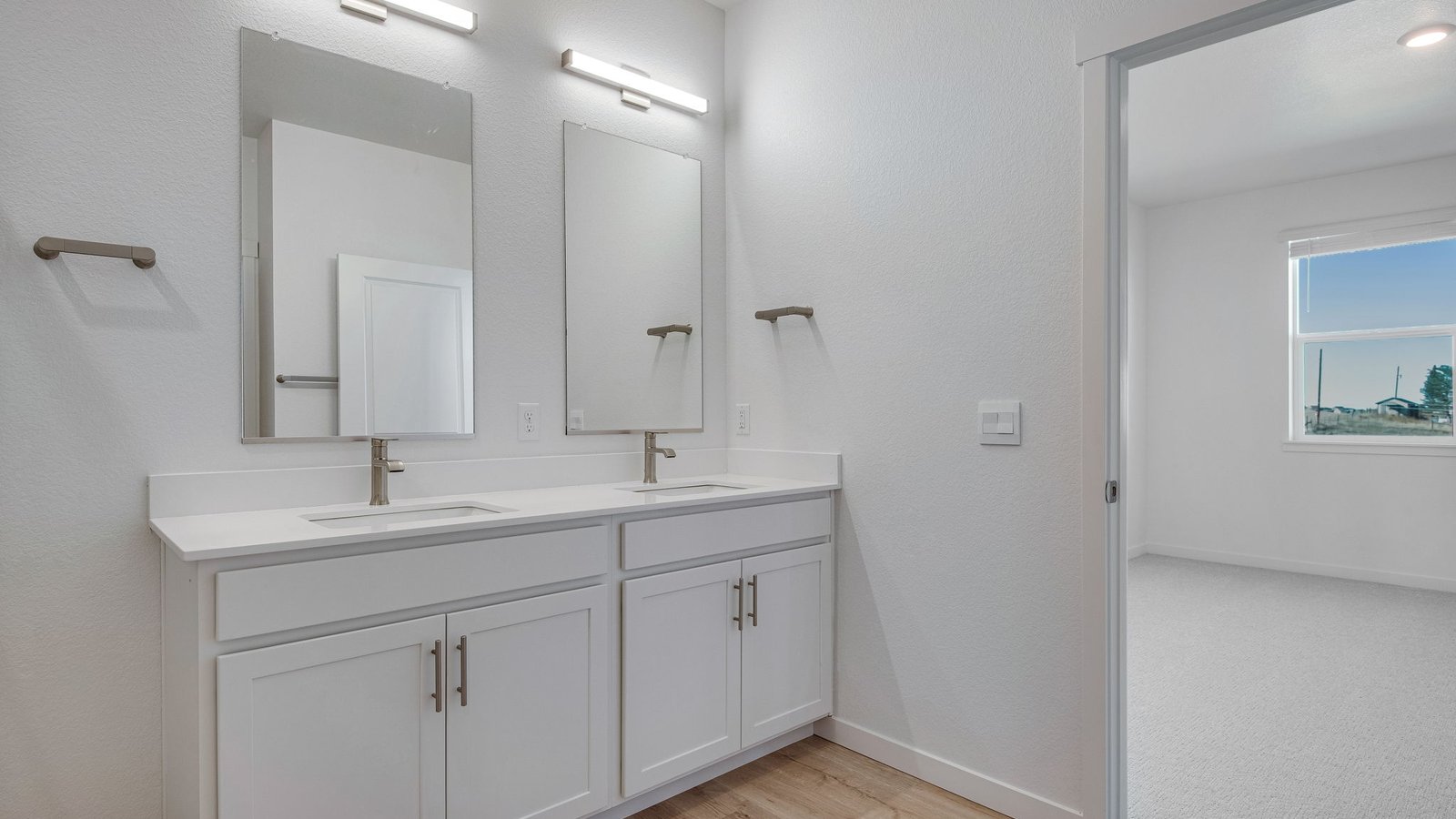 Bathroom with white cabinets new home