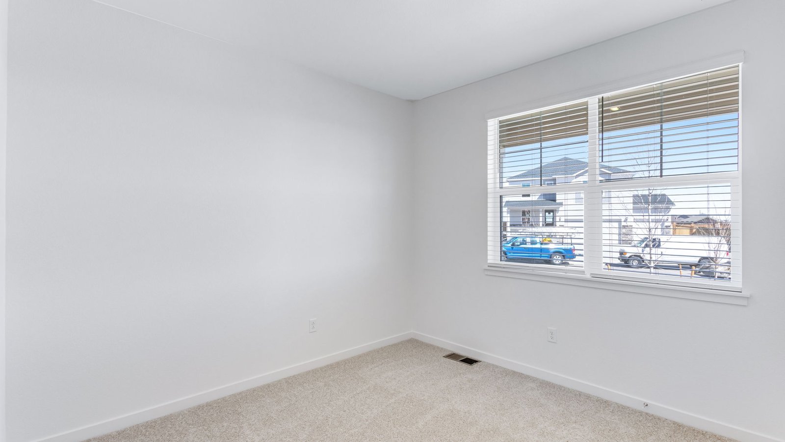 Secondary bedroom with large windows in new D.R. Horton home in Parker Colorado
