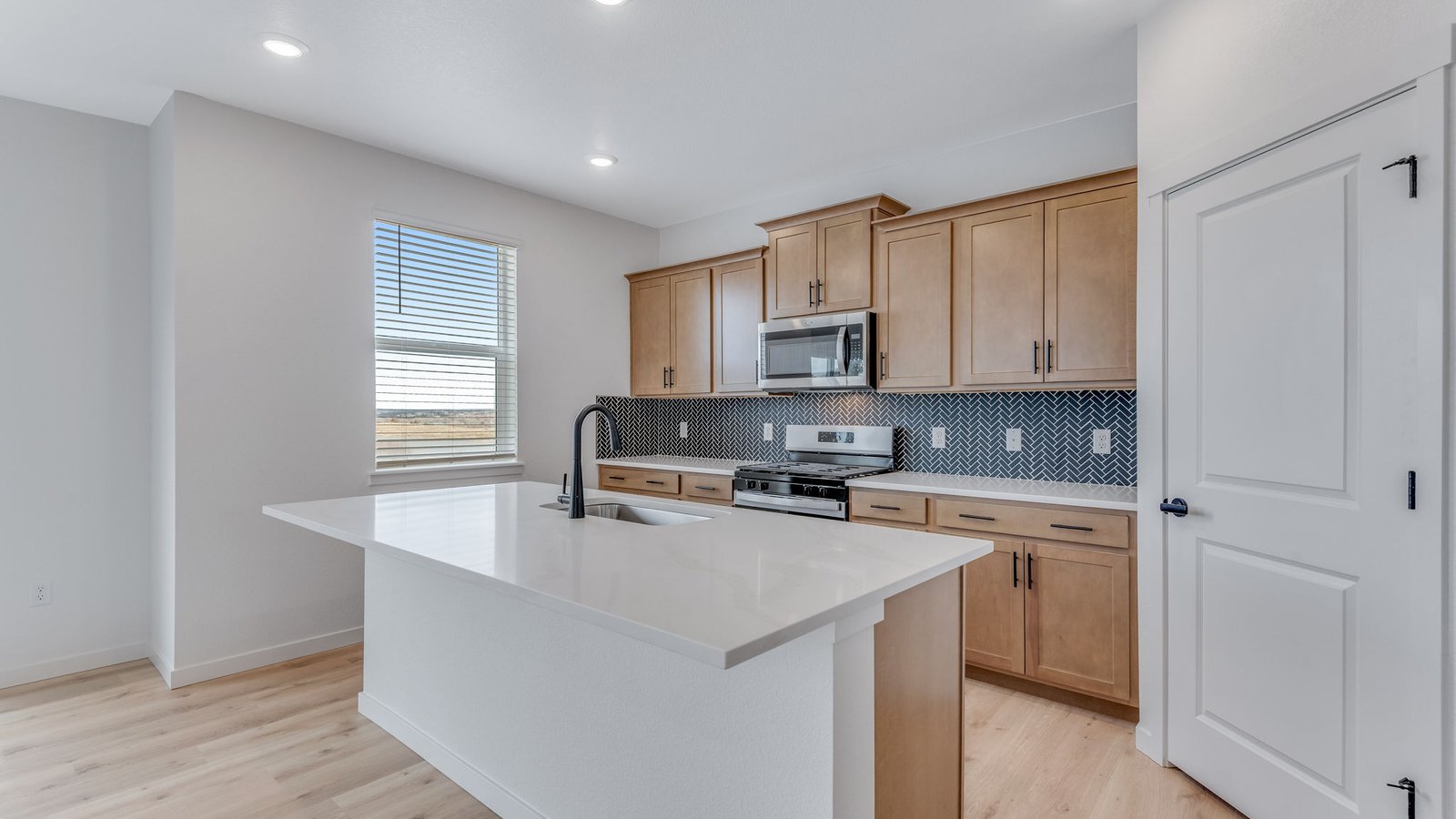 Kitchen with stainless steel appliances in new home
