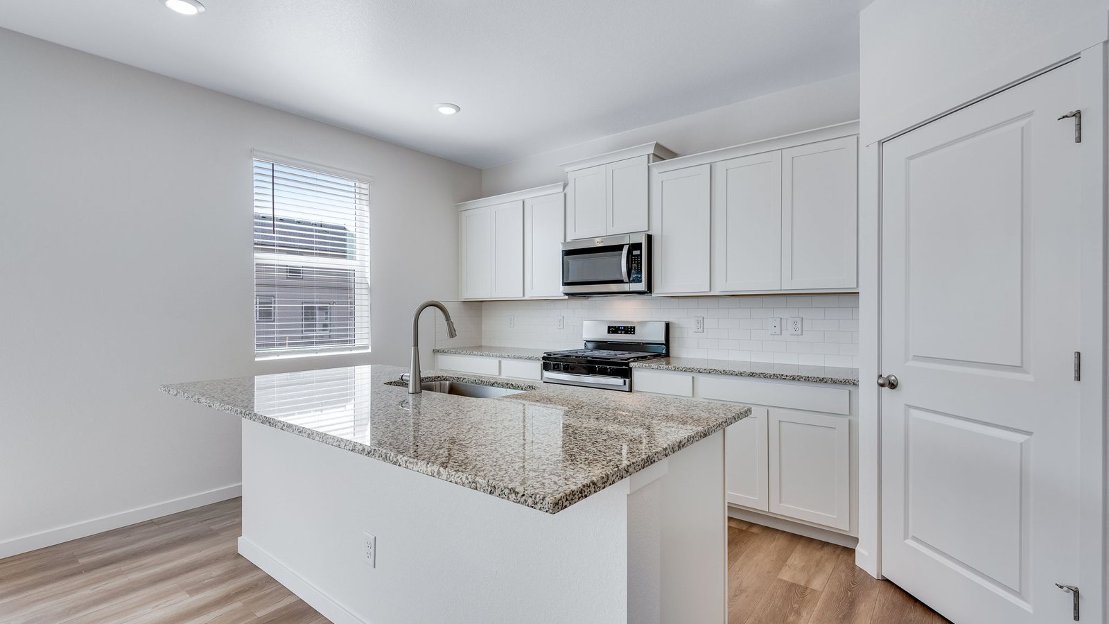 Kitchen with center island, storage cabinetry, and seamless flow for entertaining.