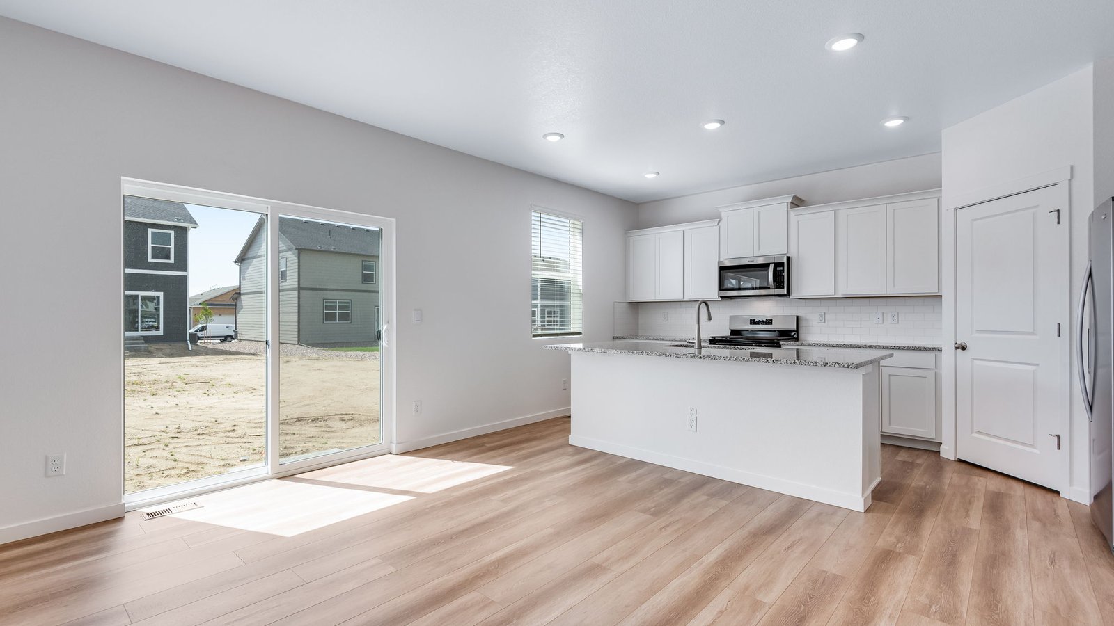 Open dining space connected to kitchen and great room, ideal for everyday meals or entertaining.
