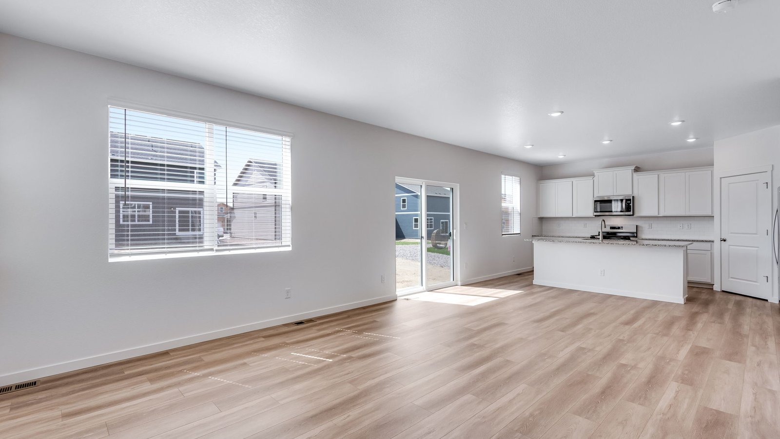 Sliding glass doors leading from dining area to backyard, bringing in natural light.