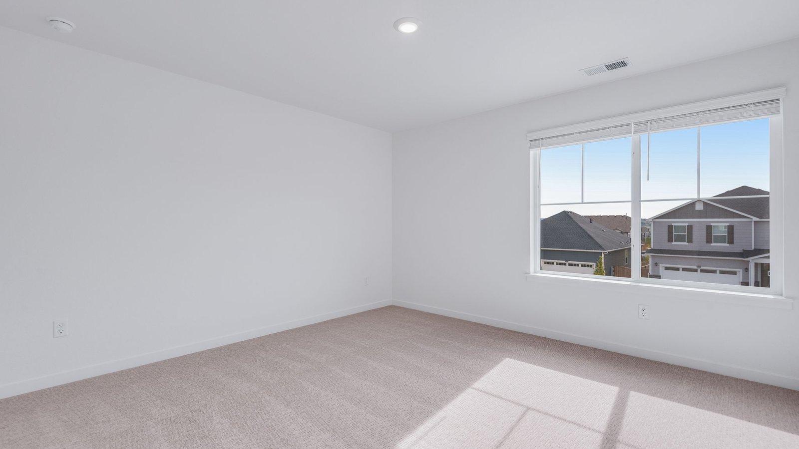 Secondary bedroom with large window in new home in Parker Colorado