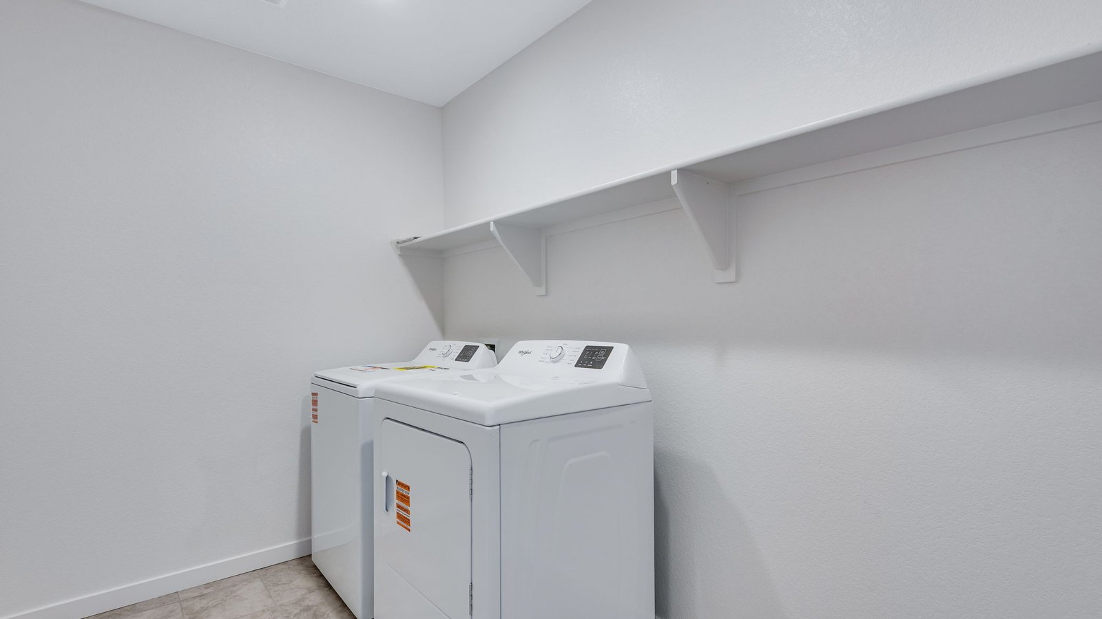 laundry room with shelf in new construction home by d.r. horton