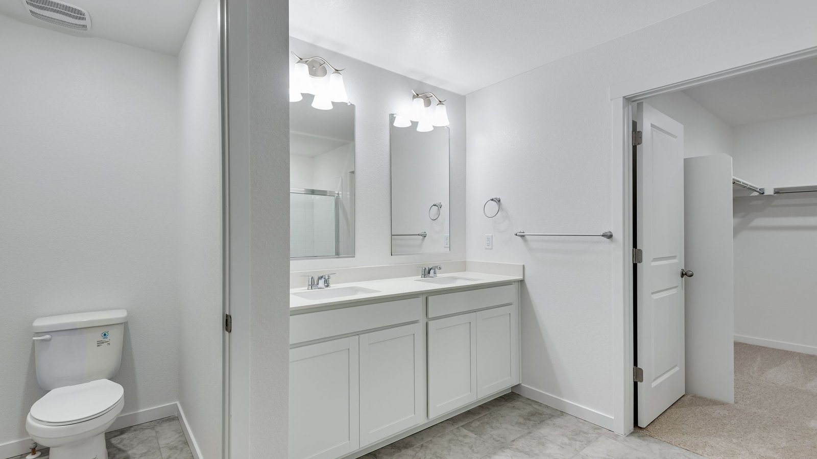 Ensuite bath featuring double vanity and modern fixtures.
