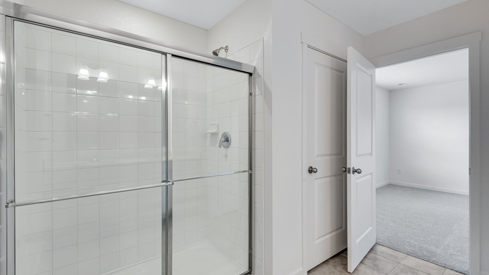Walk-in shower featuring new finishes in new construction home by D.R. Horton