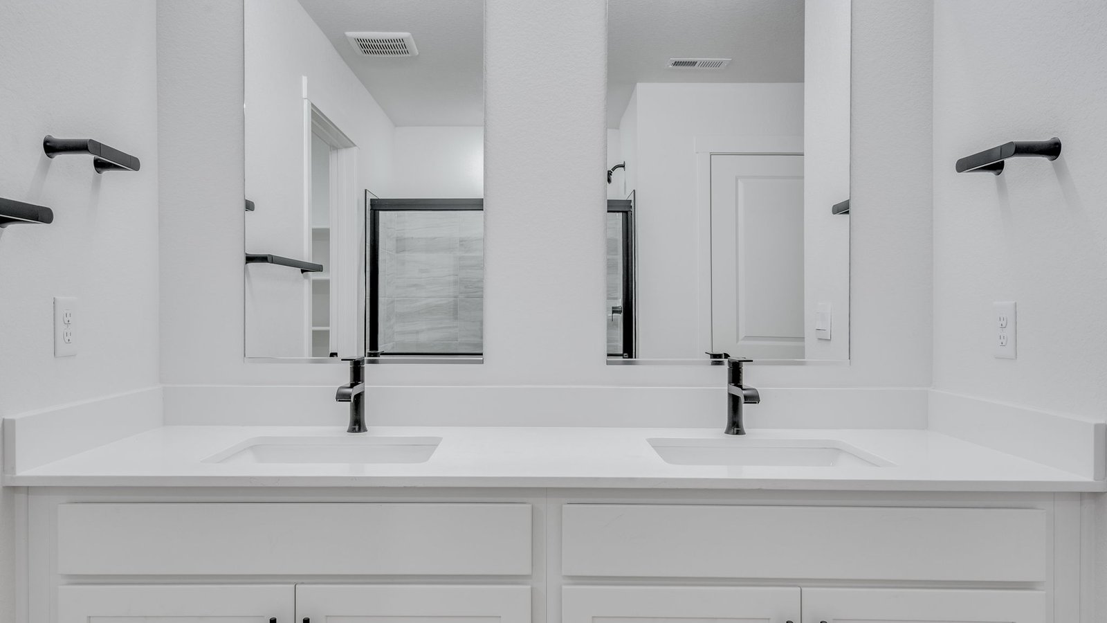 Attached private primary bathroom with dual vanity sinks in new home in Parker Colorado
