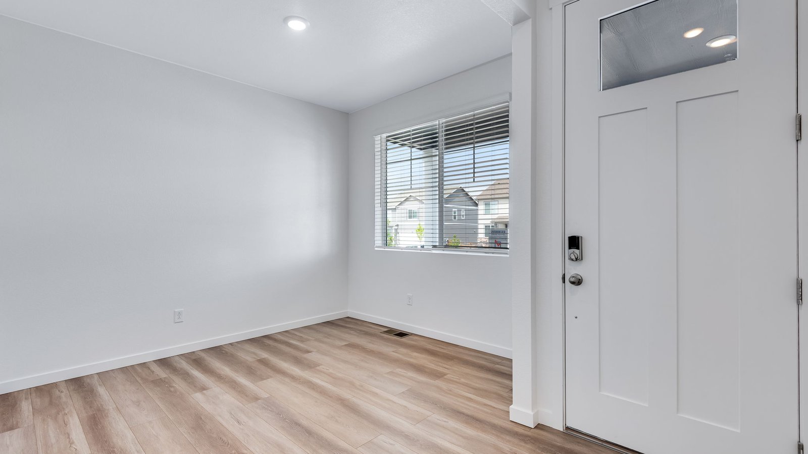 Front entry foyer in Holcombe floor plan with clean sightlines leading into open-concept living spaces and staircase access.