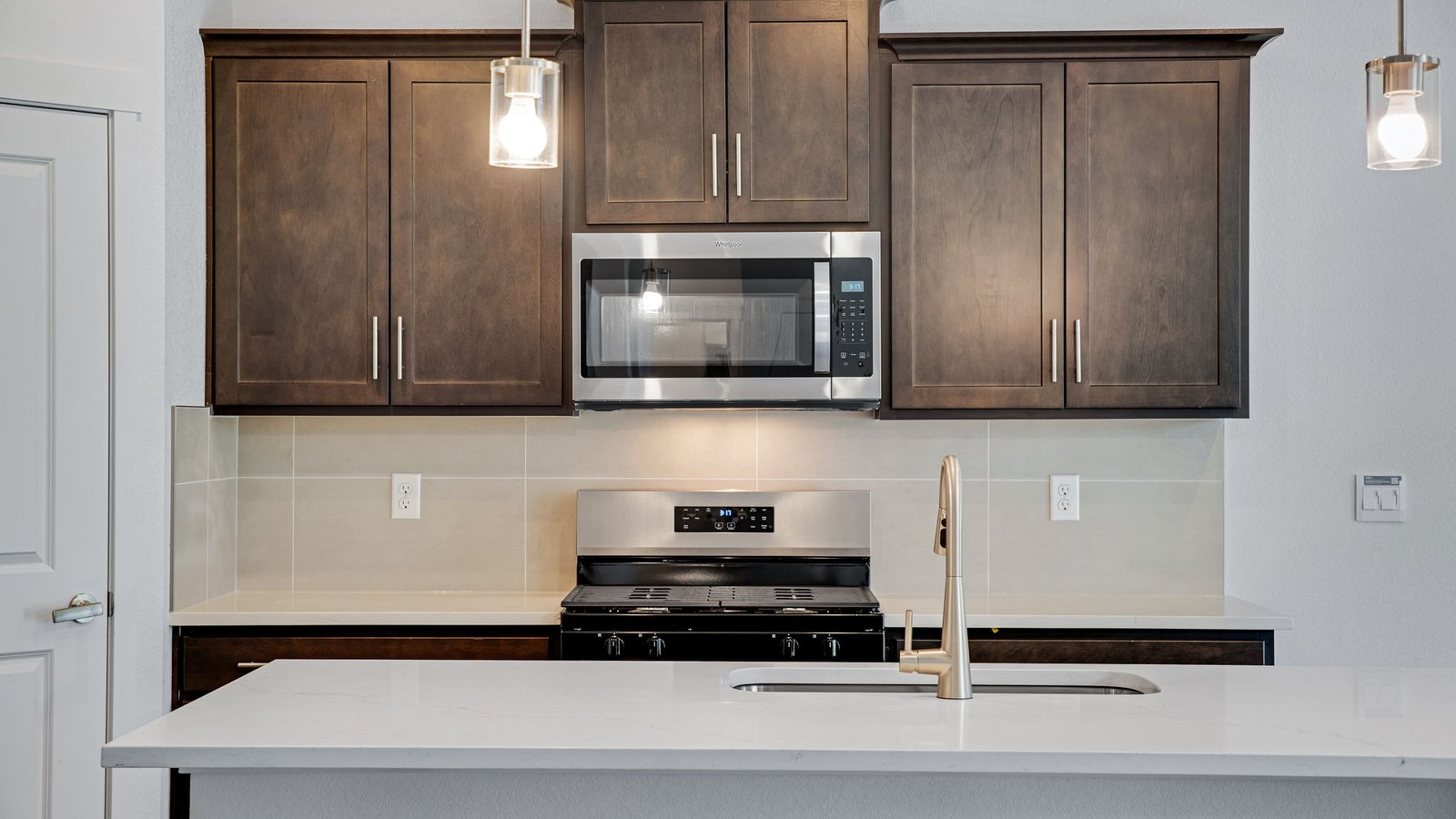 Spacious kitchen with new finishes in new home at Trails at Crowfoot community