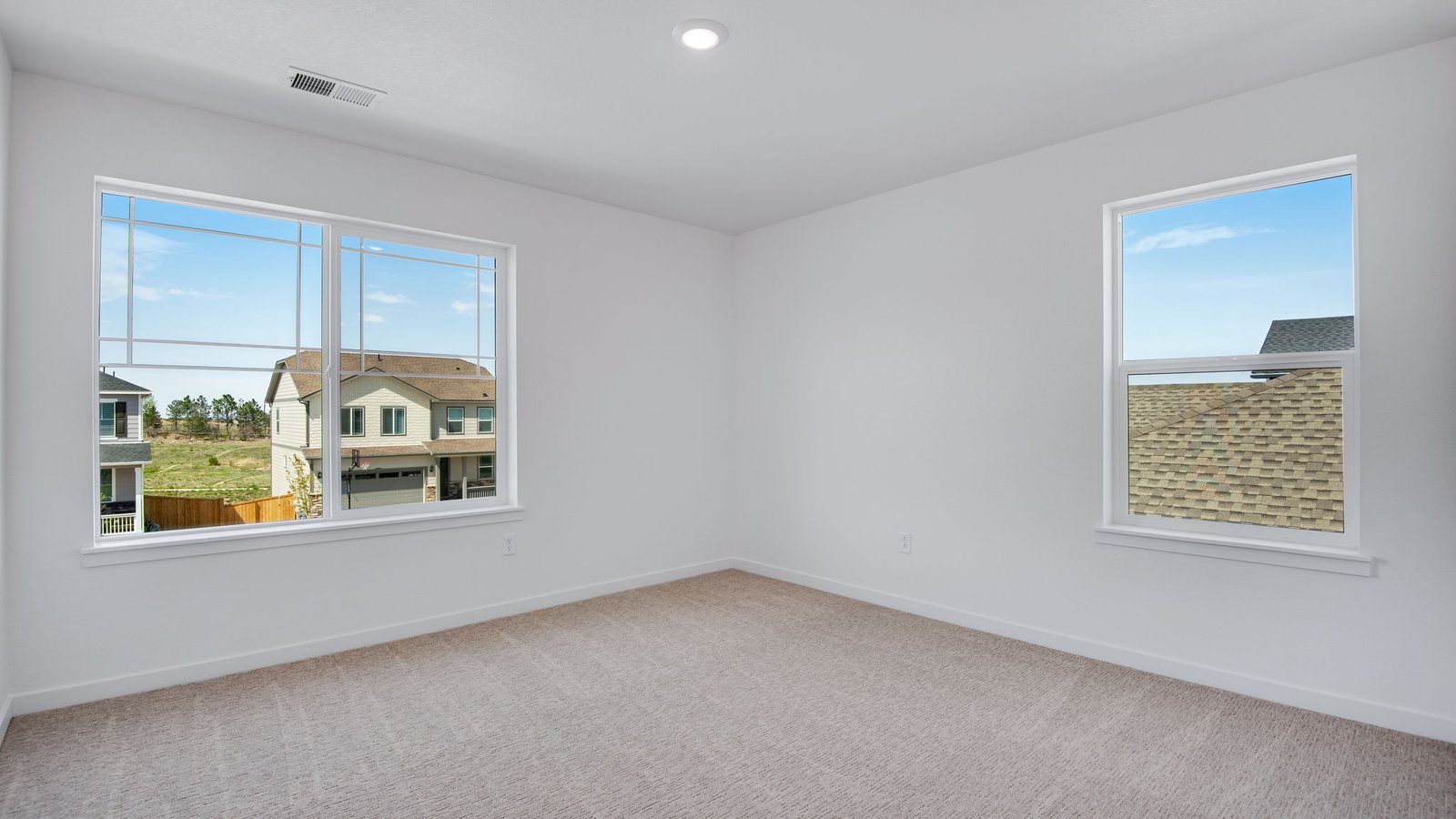 Secondary bedroom with large windows in new home community in Parker Colorado