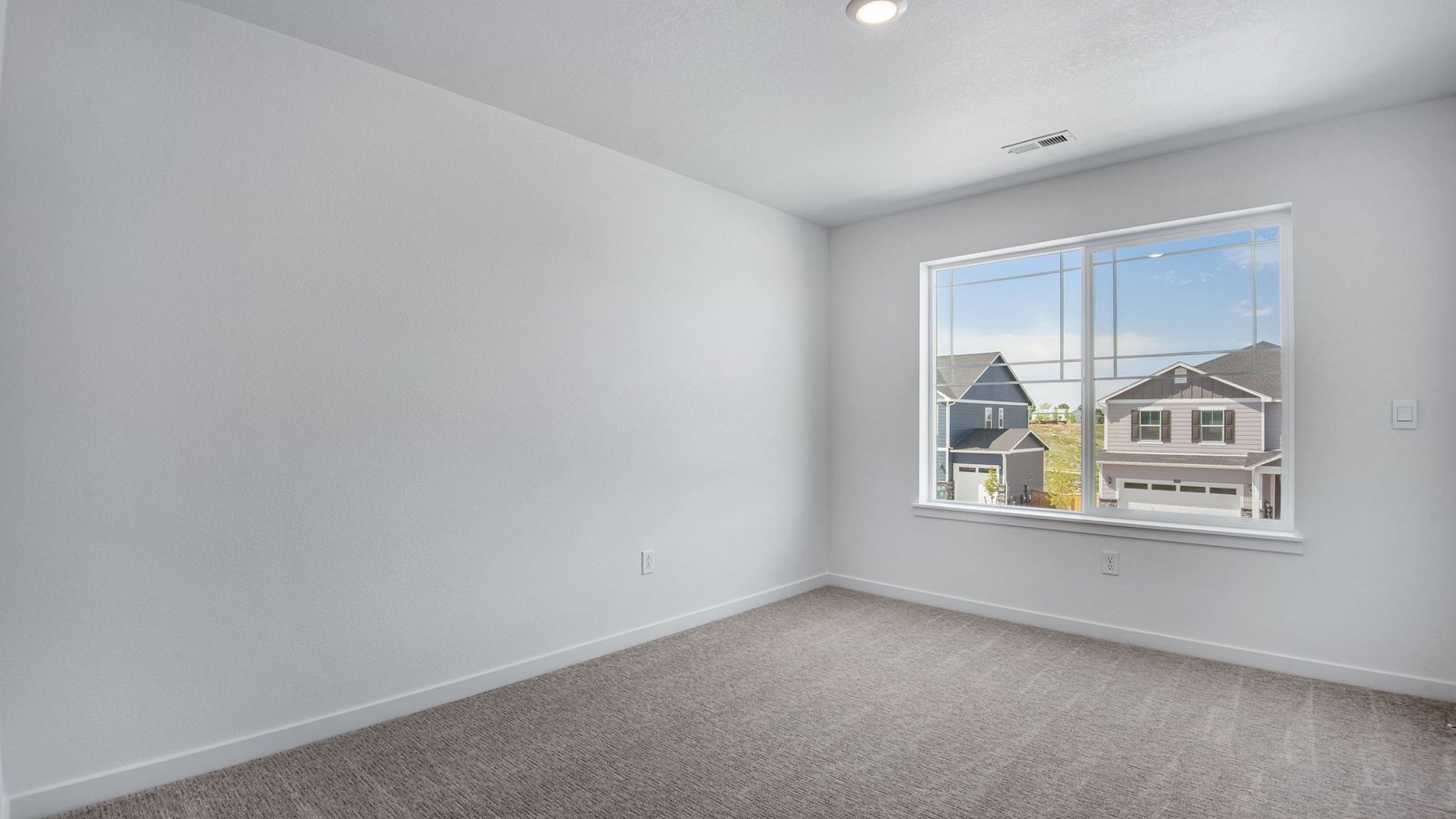 Secondary bedroom with large windows in new home in Parker Colorado