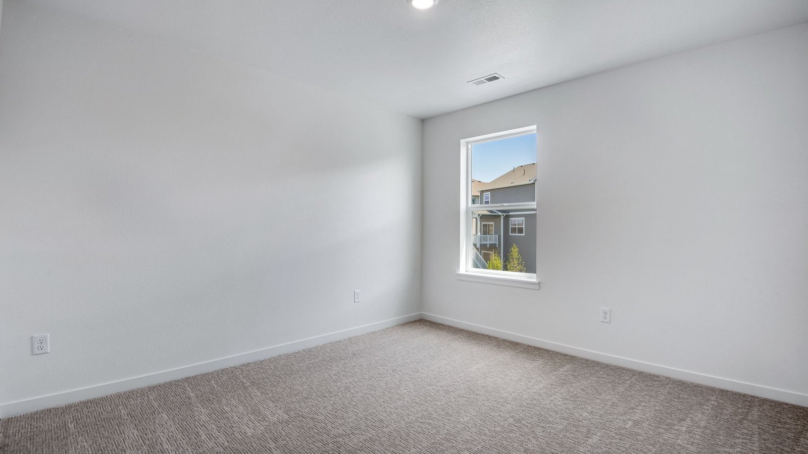 Secondary bedroom with large windows in new home in Parker Colorado